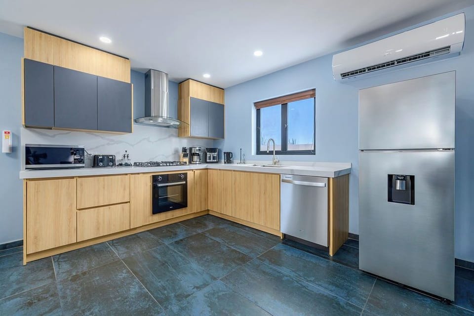 Experience the perfect blend of modern style and functionality in this gourmet kitchen. The bright, open space features sleek light-wood cabinetry and contemporary matte gray accents, creating a clean and inviting place to cook and gather.