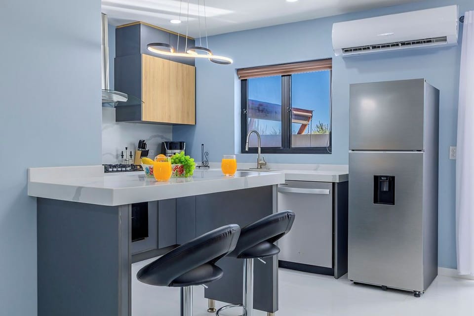 Our sleek kitchen island doubles as a cozy dining nook, perfect for a quick breakfast or a casual glass of wine while the chef of the group is at work.
