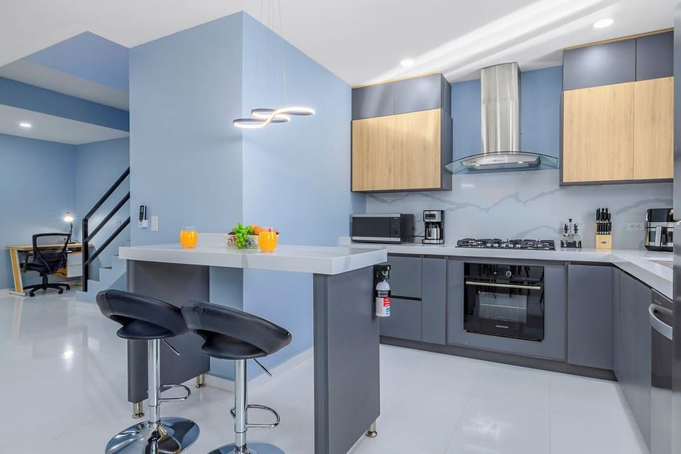 Our sleek kitchen island doubles as a cozy dining nook, perfect for a quick breakfast or a casual glass of wine while the chef of the group is at work.