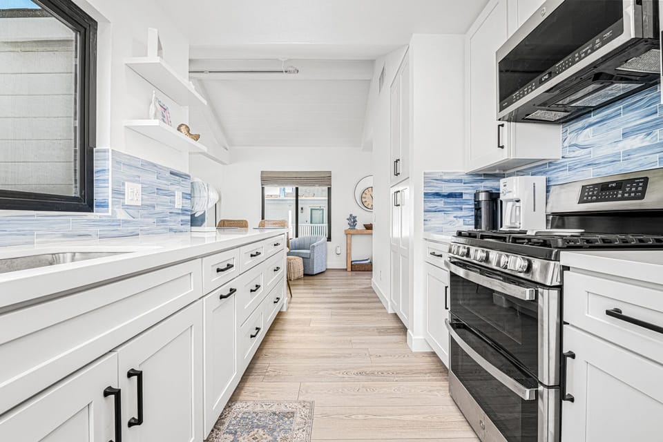 Beautifully upgraded kitchen with ample counterspace, custom cabinetry, and modern finishes
                