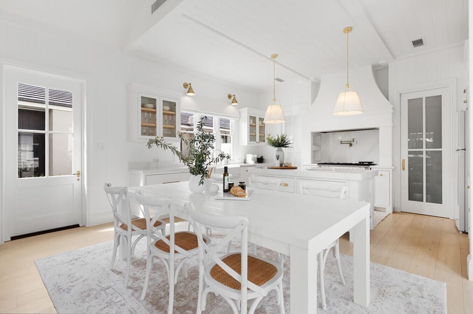 Light-filled kitchen, with large island bench and separate casual dining for eight. Fully equipped for group stays. Including Gran Lattissima coffee machine, country electric oven with gas stove top and dishwasher with easy access to full laundry.