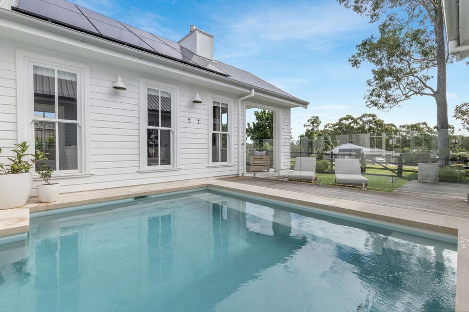 Seasonally heated private pool with timber deck and sunloungers, opening directly from the main residence. The Vintage Resort, Hunter Valley.