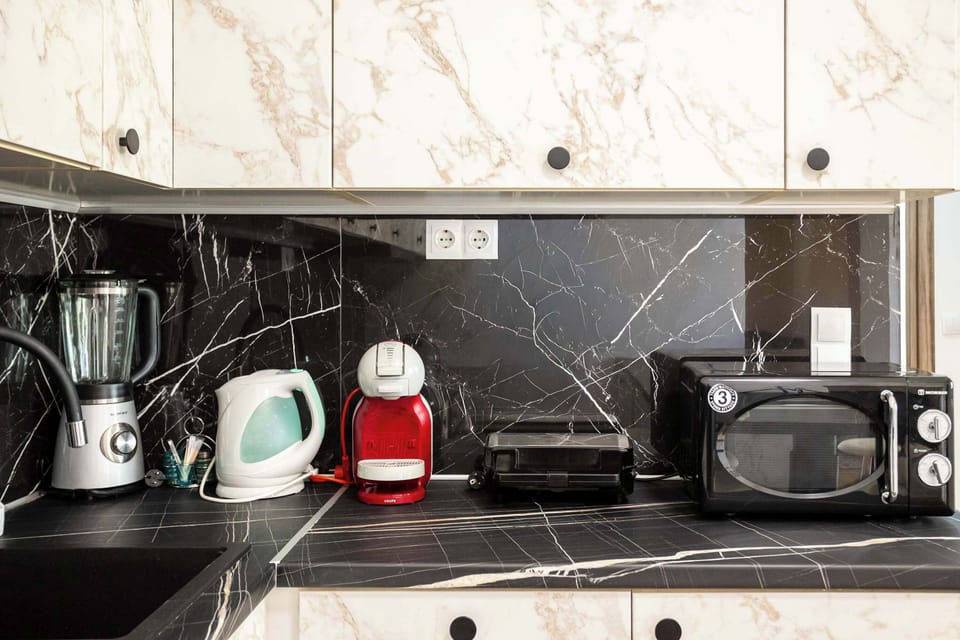 Coffee station with kettle, toaster, and essentials.