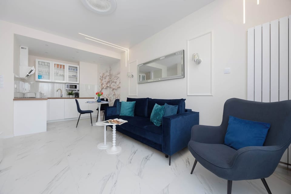 The open-plan layout allows for a smooth transition between the cozy seating area and the contemporary kitchenette.