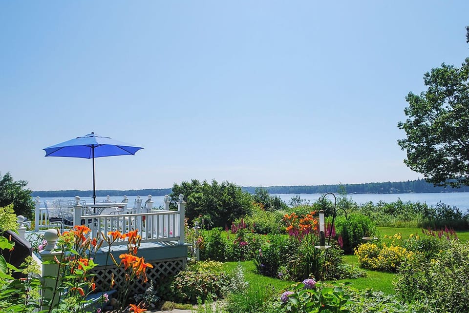 The beautiful gardens and water frontage at Bayberry Cottage