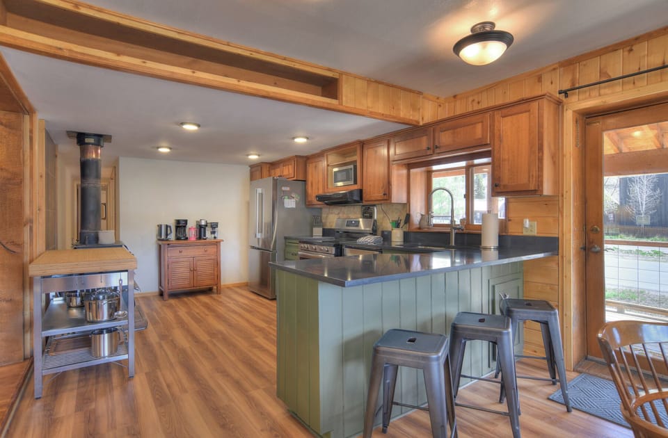 Cobbler's Claim - Open kitchen with stainless steel appliances and coffee bar.