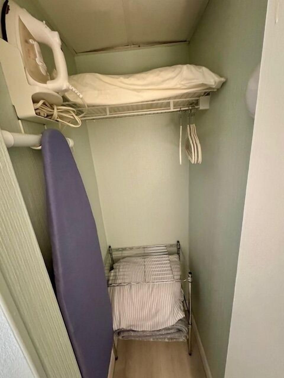 Closet with iron and ironing board