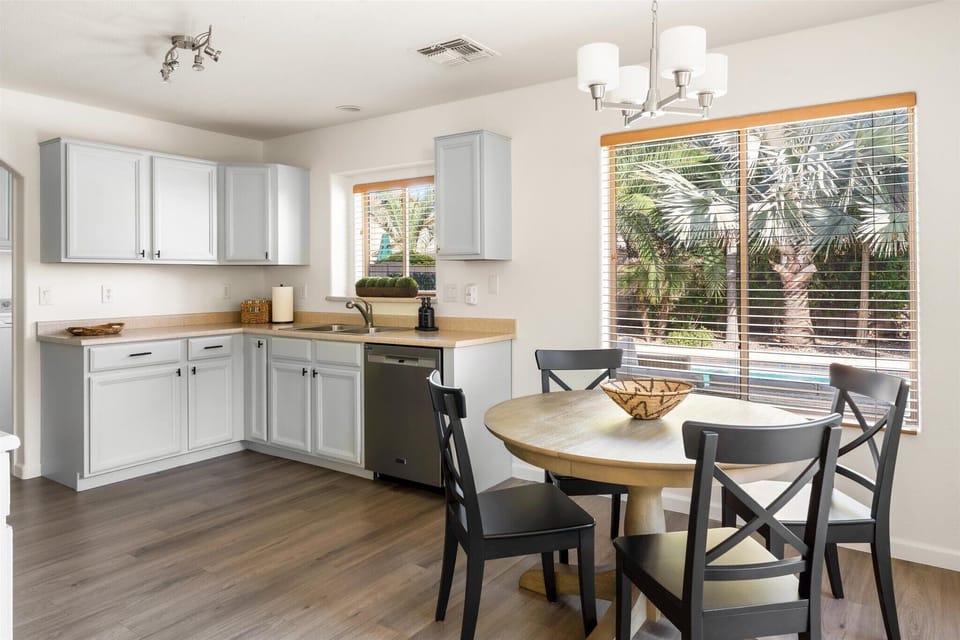 The fully stocked kitchen is light and bright.  Eat in dining area with seating for 6 (includes an additional extension if needed)