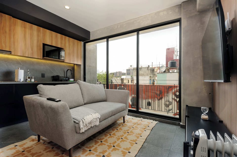 Inviting living room with plush seating and direct access to the balcony.