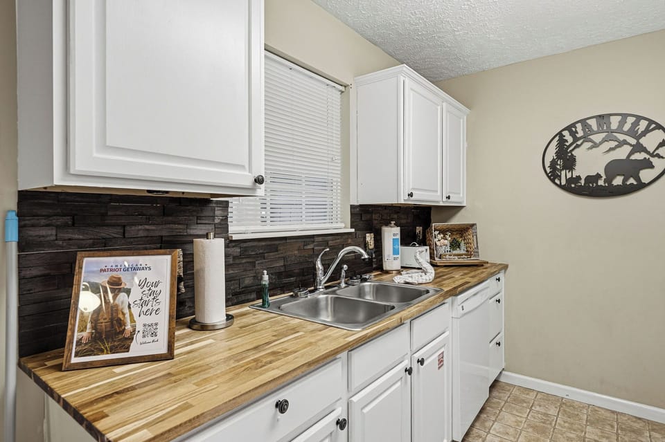 Your fully-equipped kitchen features warm wood countertops and modern appliances, perfect for preparing meals during your stay.