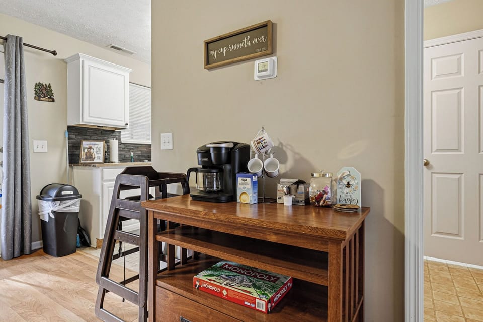 Your morning coffee station awaits with everything you need to start each day perfectly in this thoughtfully organized space.