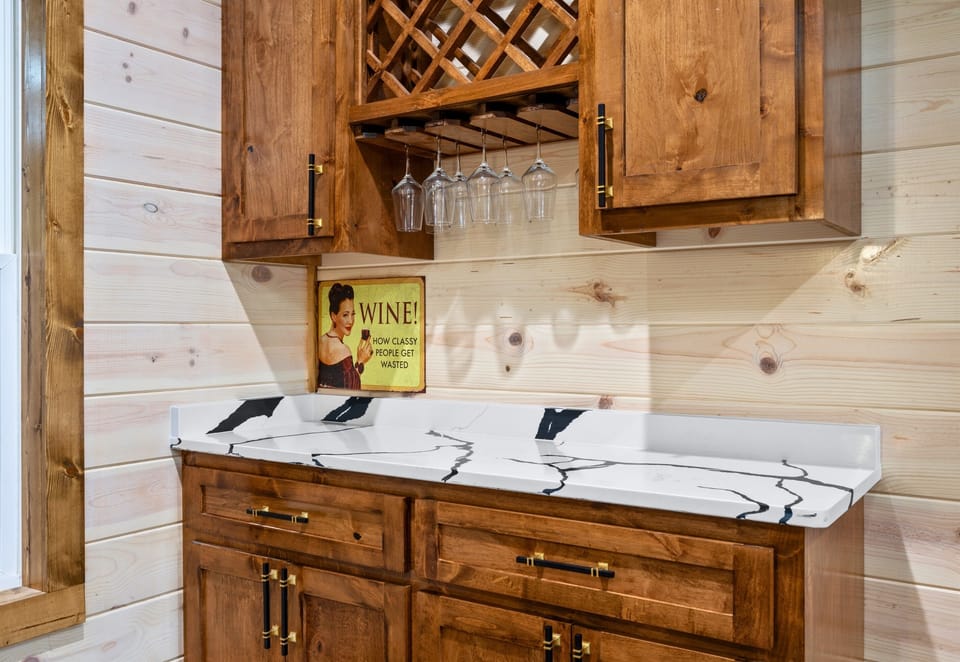 A charming built-in bar area keeps wine glasses and your favorite drinks close at hand for relaxed evenings at the cabin.