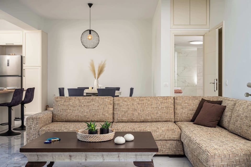 Open-plan interior with dining, kitchen, and sitting area flowing together in one bright and practical space, designed for relaxed holidays with comfort and convenience in mind.