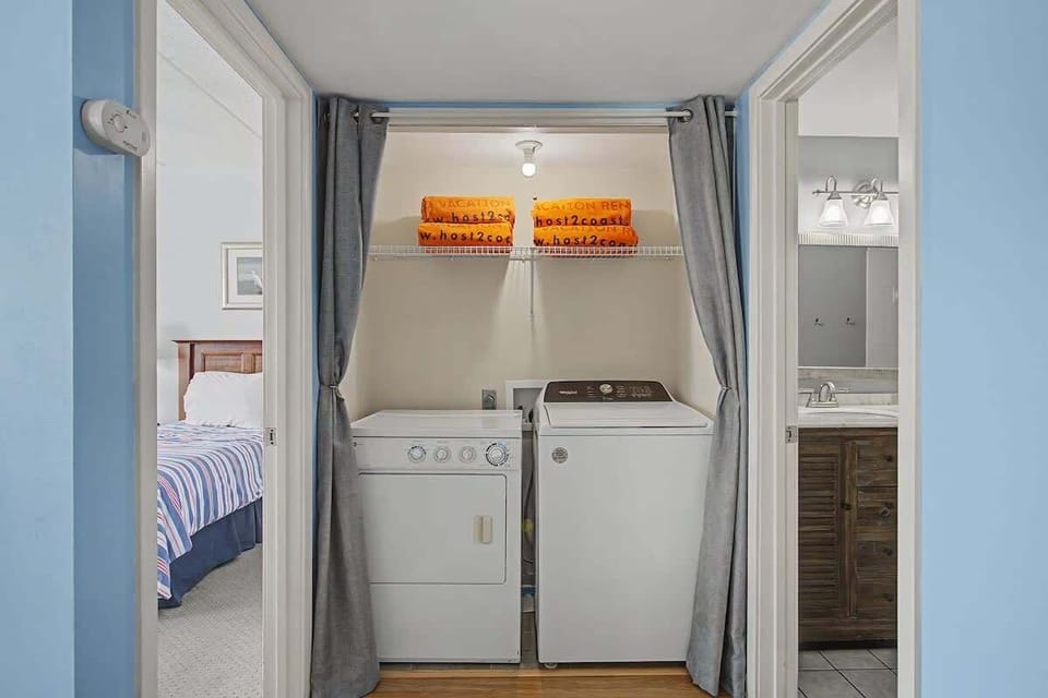 Your private laundry alcove keeps your clothes fresh, with convenient washer and dryer tucked neatly away behind soft curtains.