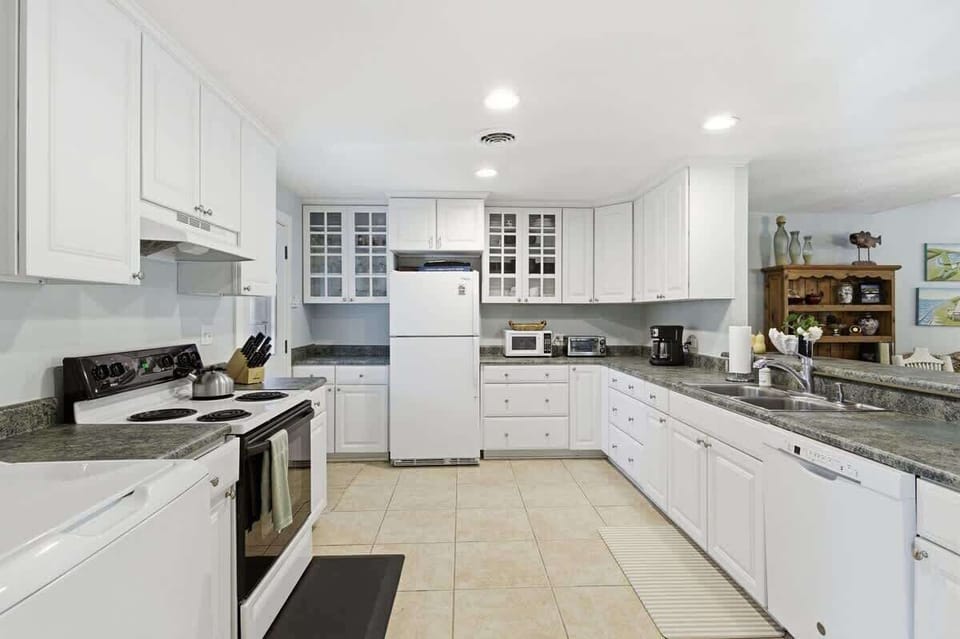 Your spacious kitchen features granite countertops, white cabinetry, and all the appliances you need for memorable meal preparation.