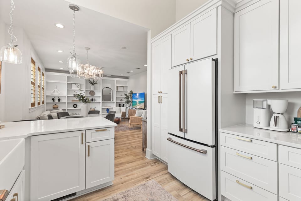 Your spacious chef's kitchen features pristine white cabinetry, gleaming countertops, and premium stainless steel appliances for memorable meal preparation.