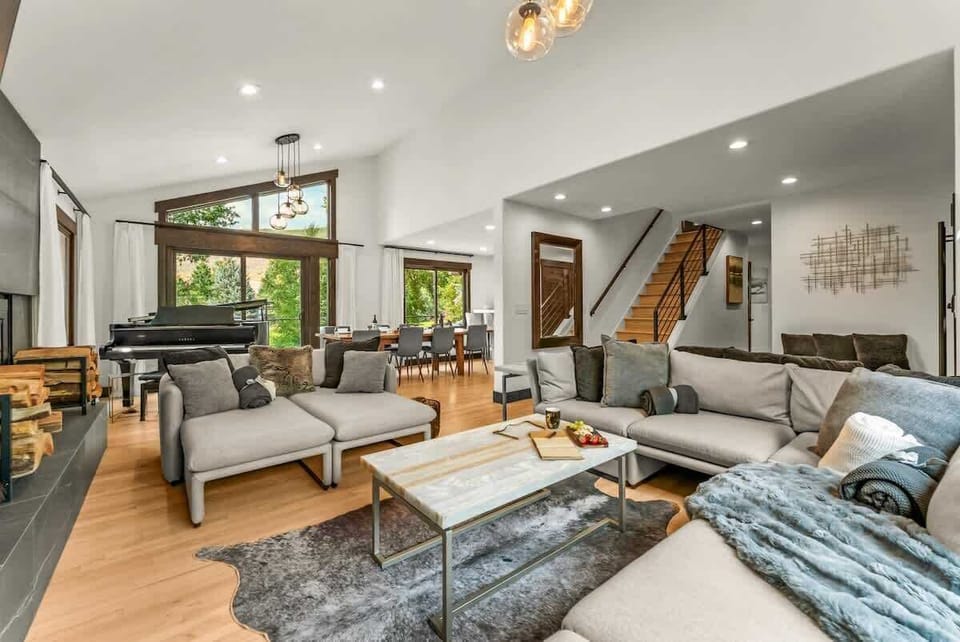 Living room: Wood-burning fireplace, Smart TV, Sonos surround system, piano, main floor