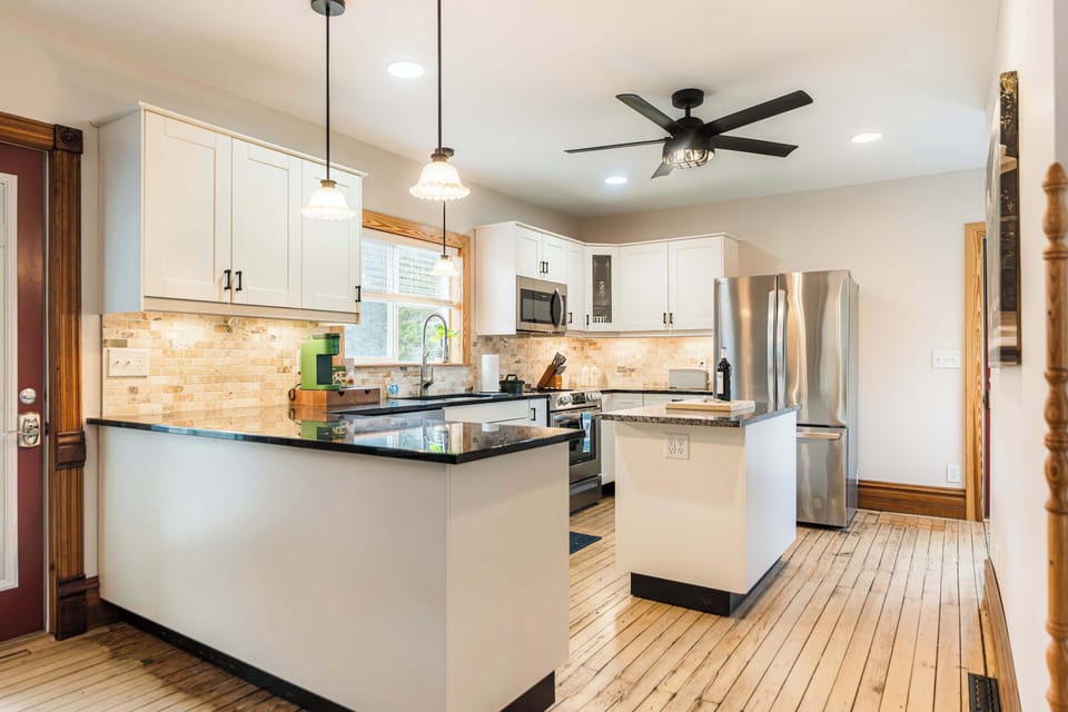 Bright kitchen with modern appliances and ample space for cooking and dining.