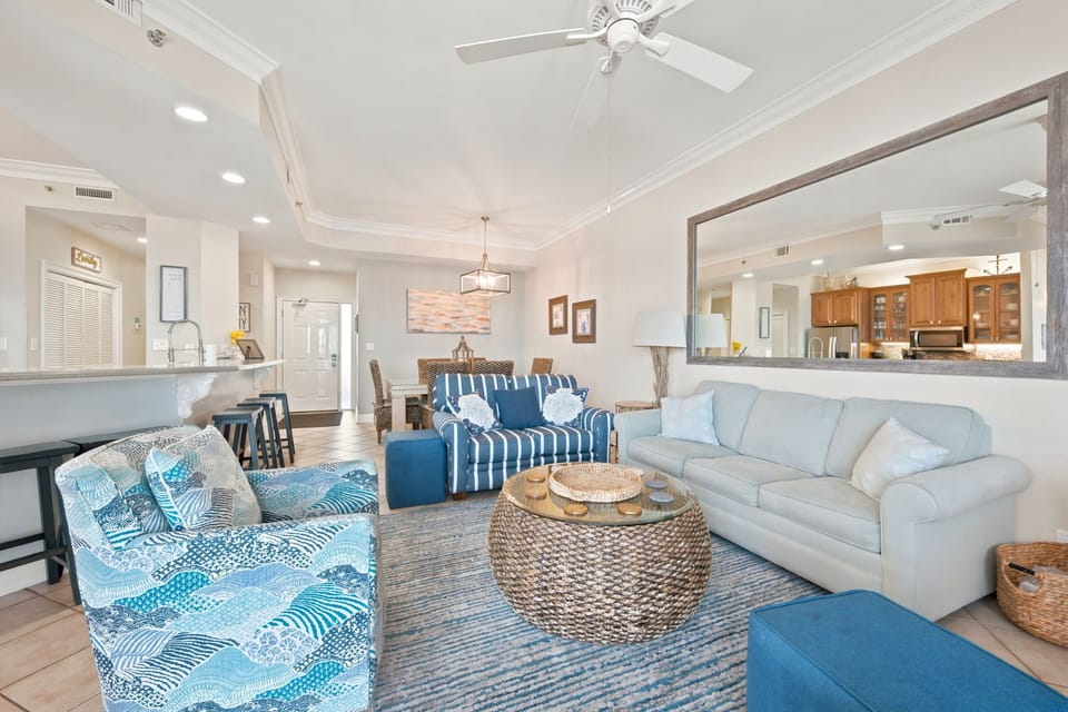 SeaChase 1104C-Sink into plush coastal-inspired seating and unwind in your open-concept living space, where natural light, beachy blues, and woven textures create a breezy, welcoming retreat perfect for your group getaway.