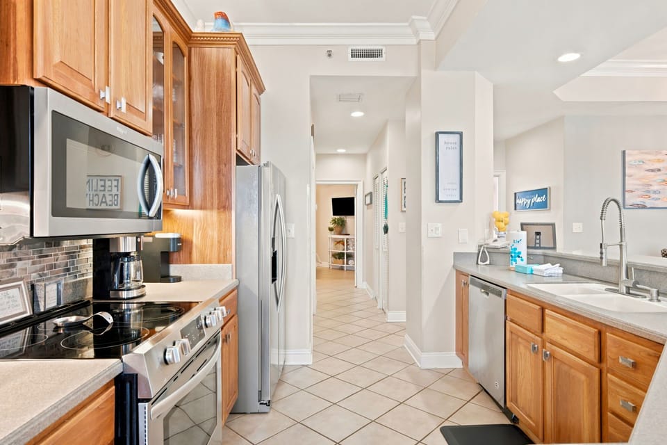 SeaChase 1104C-Your fully-equipped galley kitchen invites you to prepare meals with ease. Stainless appliances, warm wood cabinetry, and ample counter space create a comfortable and functional cooking environment.