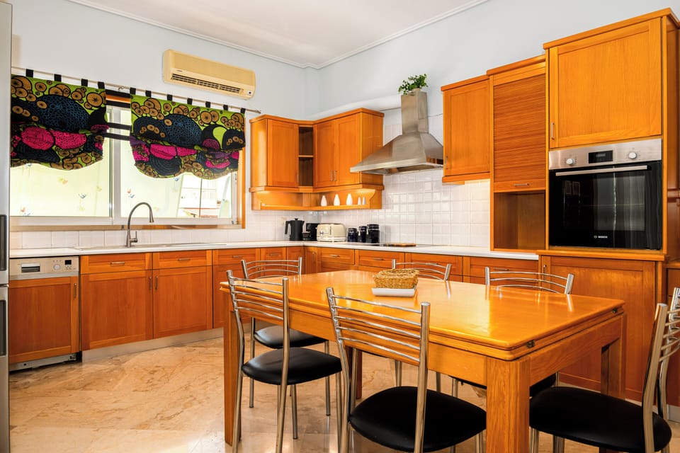 Bright dining area with a sleek table and comfortable seating for six.