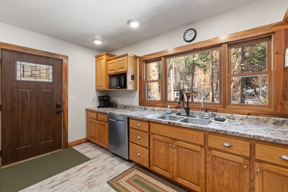 A spacious kitchen, with expansive countertops and sunlit windows, makes cooking a joy.