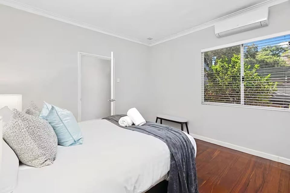 Bedroom 2 : Soft bedding, natural light and timber floors give this bedroom at Sasha’s Cottage on the Hill a simple, welcoming feel.