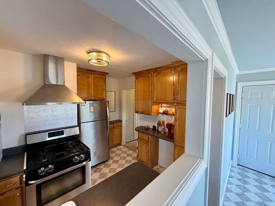 Fully equipped kitchen with stainless appliances, gas range, and coffee station.
