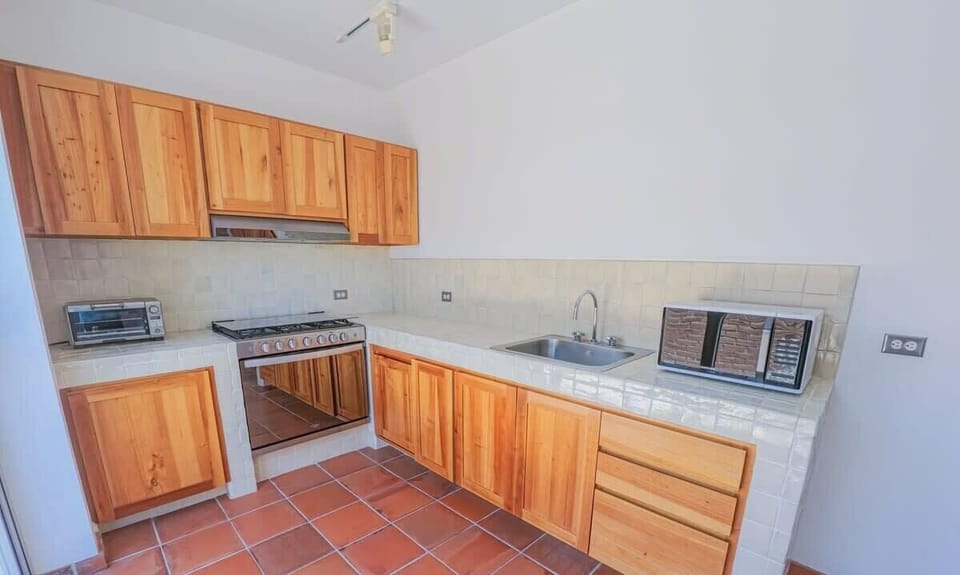 Equipped with a microwave, toaster, and essential cooking basics.