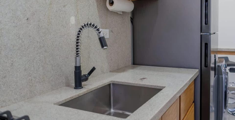 This kitchen features a large sink, ideal for fast and easy clean-ups.