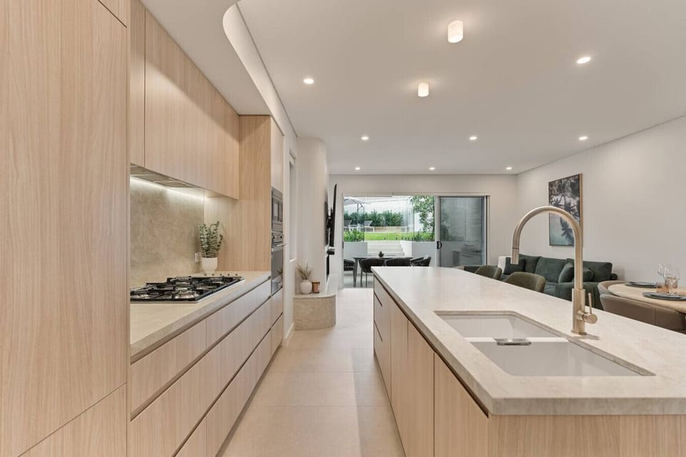 Chef-inspired kitchen with premium appliances, stone benchtops and a spacious island perfect for entertaining.