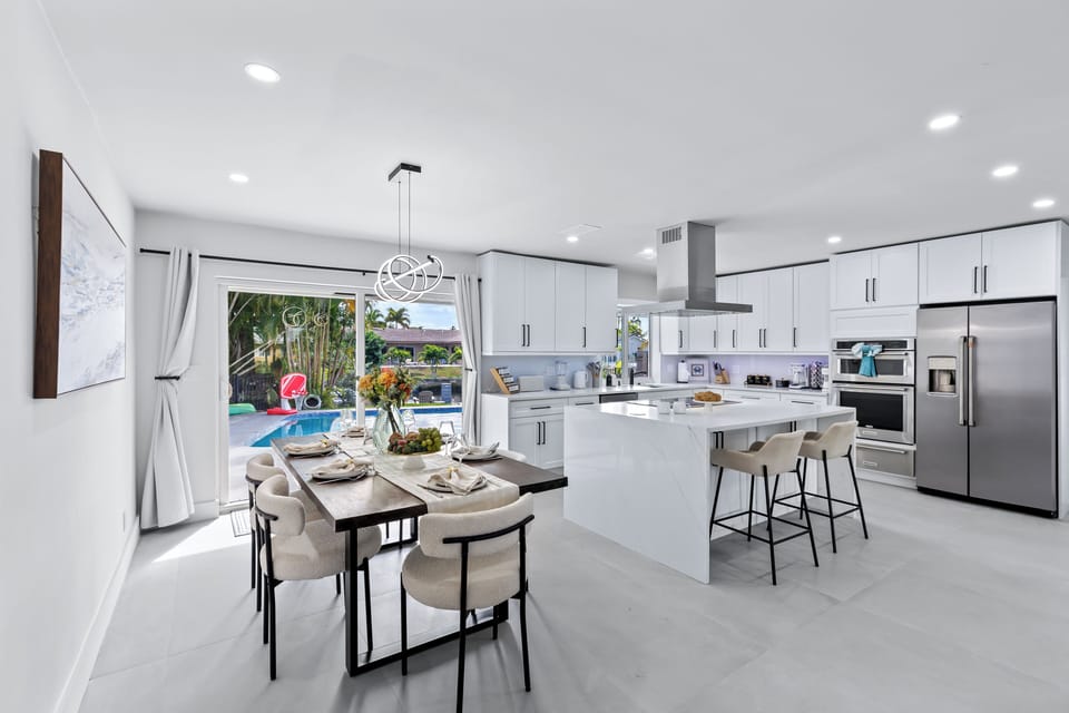 Bright, open-concept kitchen + dining with a seamless flow to the pool—perfect for morning coffee, family meals, and easy indoor-outdoor entertaining.