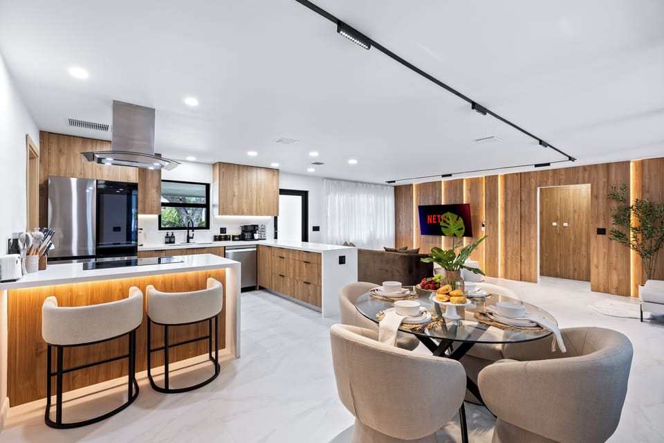 Open-concept kitchen, dining, and living area with a clean modern design.