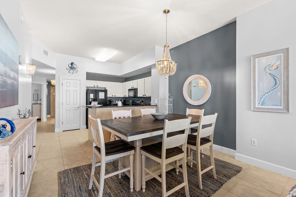 There is a dining table, perfect for enjoying a meal or playing a game, as well as additional breakfast bar seating.