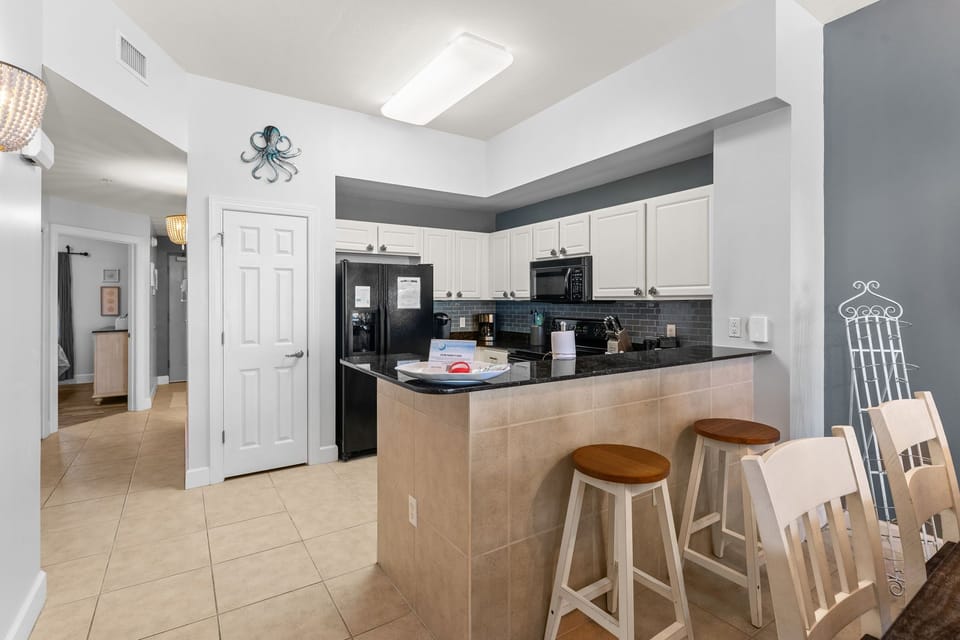 There is a dining table, perfect for enjoying a meal or playing a game, as well as additional breakfast bar seating.
