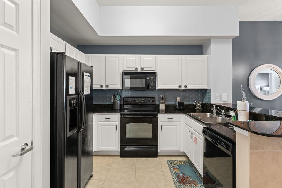 The fully equipped kitchen features granite countertops and has everything you need to prepare meals for family & friends.