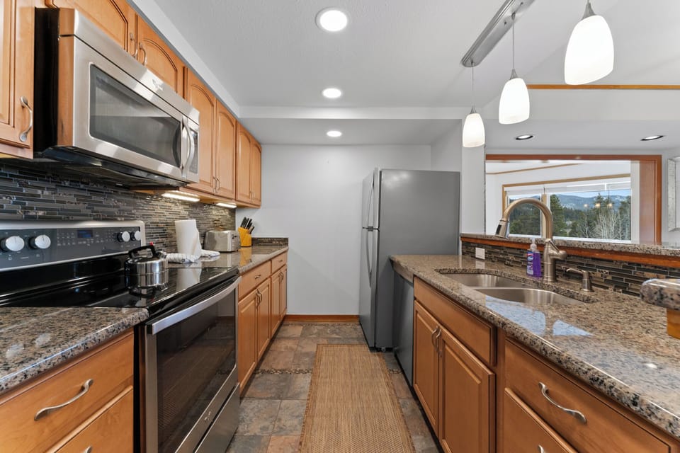 Full kitchen with stainless steel appliances.