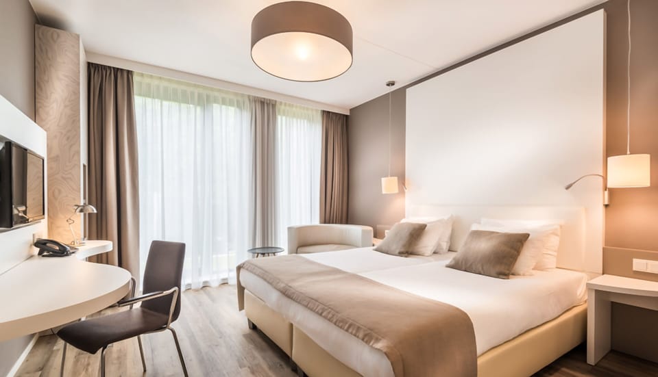 Unwind in a bright, airy room with crisp linens.