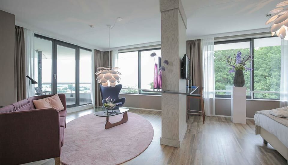 Wake to treetop vistas from your bright, open-plan suite.