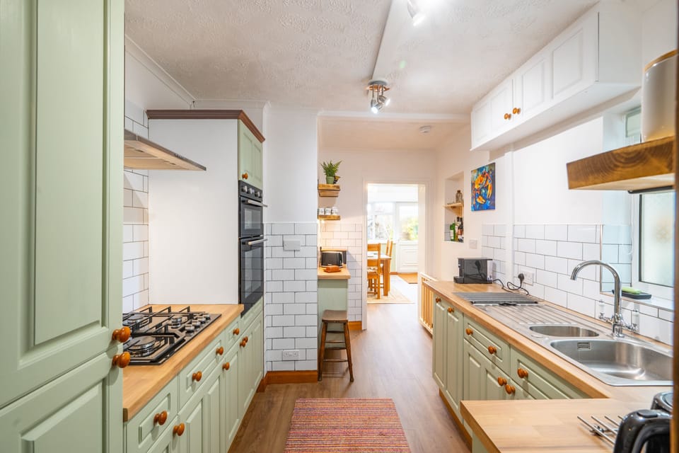 Clifftop Cottage, East Runton: Along the hallway toward the back of the property is a well-equipped kitchen which opens up into a light and airy dining/ garden room