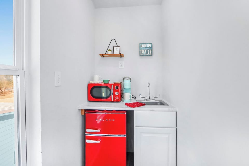 The kitchenette features a mini fridge and microwave