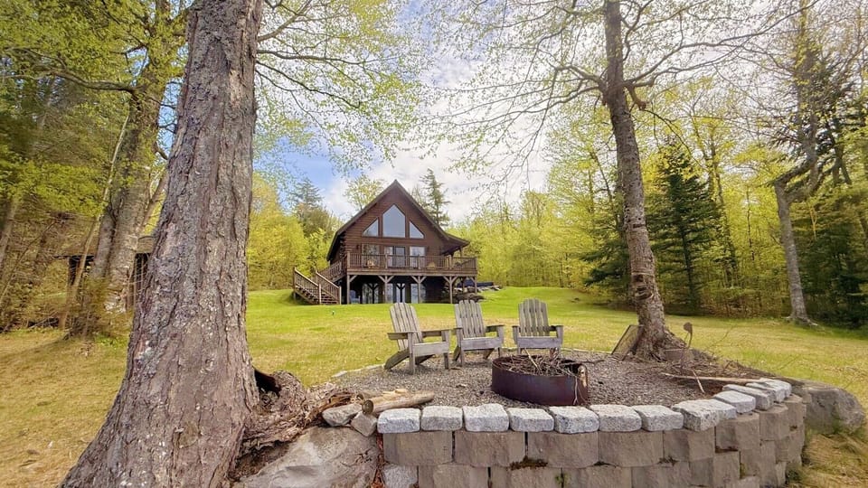Peaceful retreat with a spacious deck, outdoor fire pit, and classic Adirondack seating.