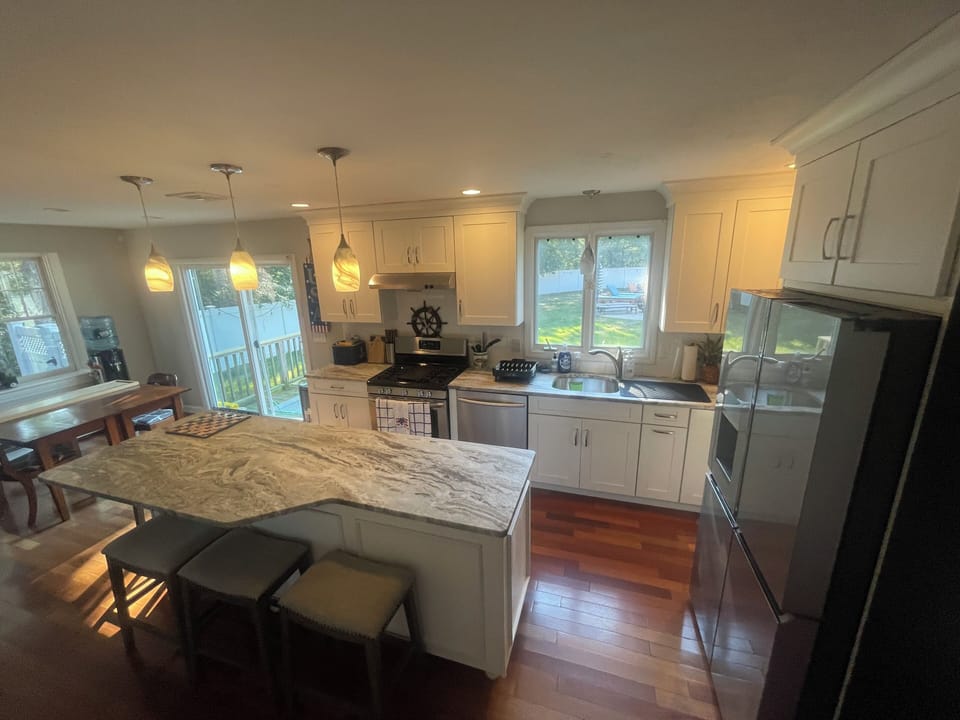 Your spacious kitchen features granite countertops, stainless appliances, and pendant lighting perfect for preparing meals and entertaining.