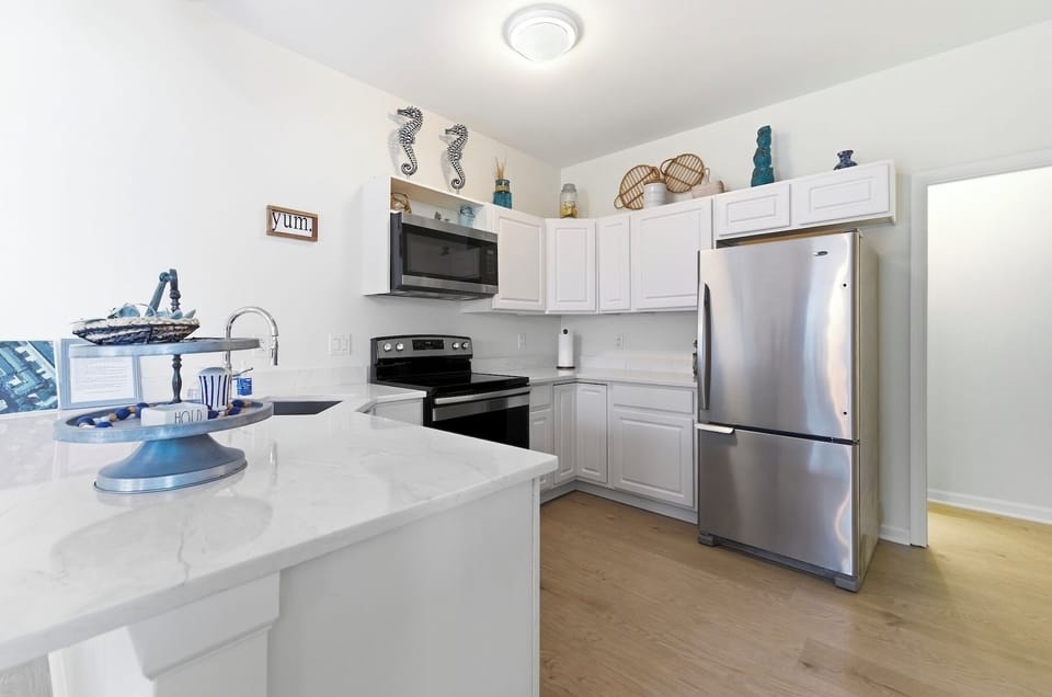 Kitchen with bright cabinets and stainless steel appliances