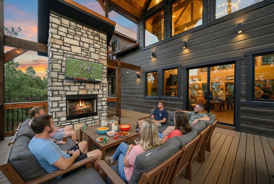 Gather around the outdoor fireplace on the expansive deck with stunning forest views and cozy seating for the whole crew.