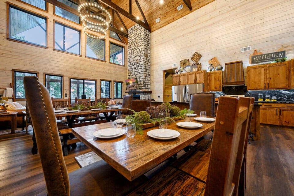 This open-concept cabin has soaring ceilings, a wood-burning fireplace, and walls of windows overlooking the trees.