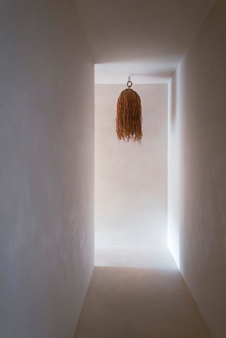 Modern hallway with a Bohemian-designed lamp.