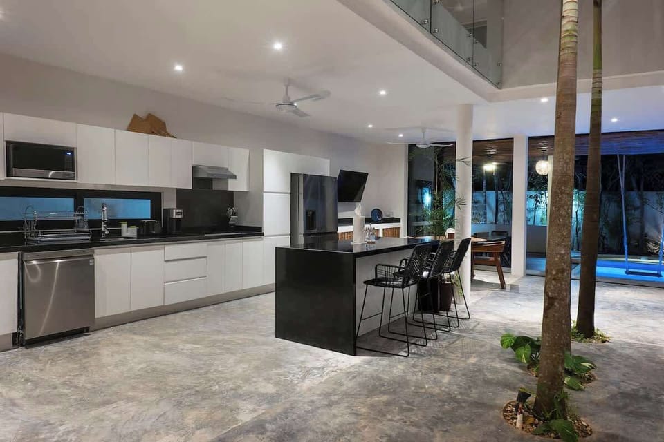 Fantastic fully-equipped kitchen with modern appliances. Natural trees in the center complete the space.