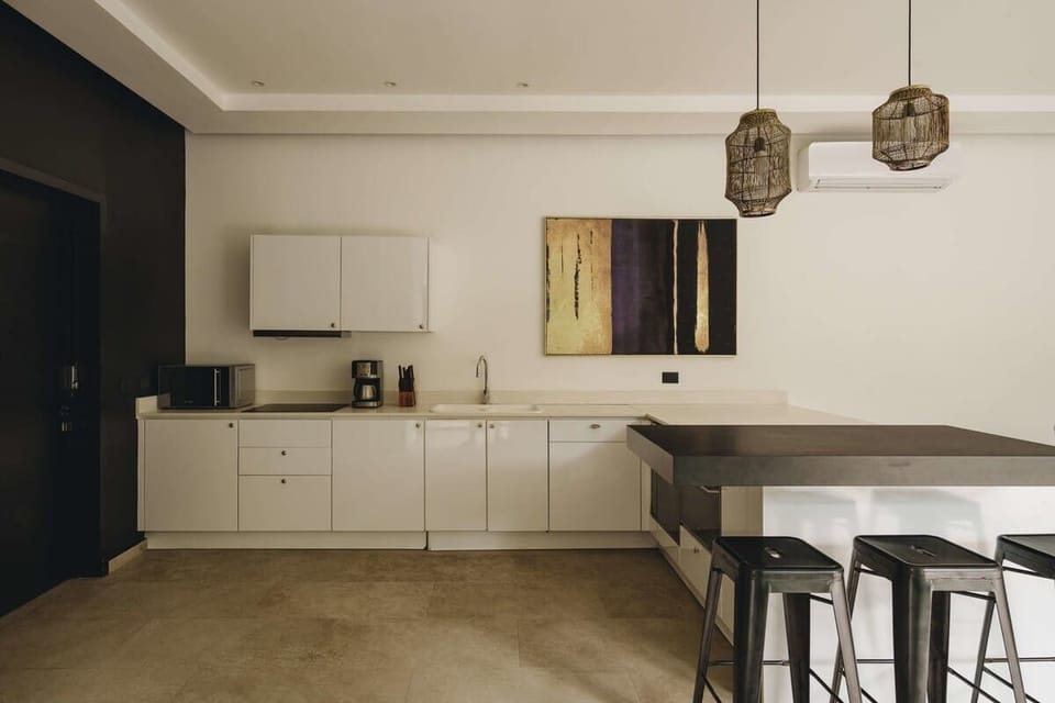 Modern fully equipped kitchen. It has a beautiful bar with seating for three people.