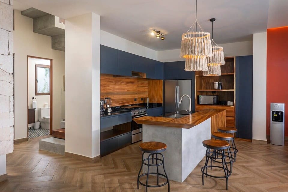 Spectacular kitchen with wood finishes. Incredible island in the center.